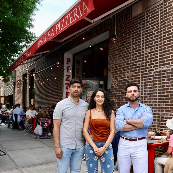 Three people standing in front of Salsa Pizzeria, with outdoor diners visible on the left.